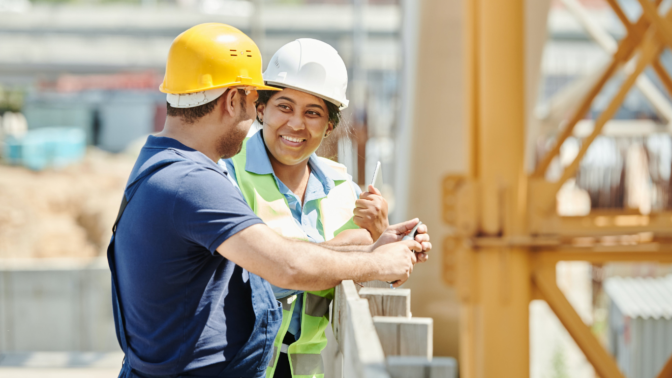 Builders in conversation on construction site.